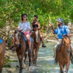 Guide leading horseback riding tour on the beach